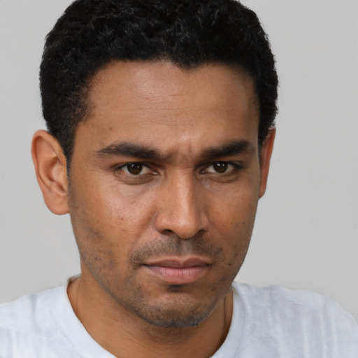 Neutral latino young-adult male with short  black hair and brown eyes
