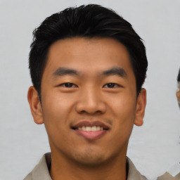 Joyful asian young-adult male with short  black hair and brown eyes