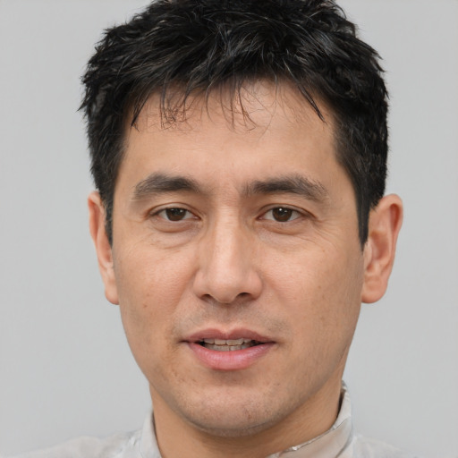 Joyful white adult male with short  black hair and brown eyes