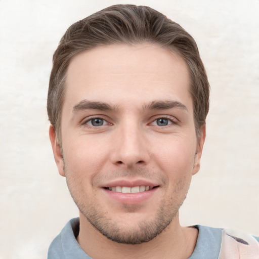 Joyful white young-adult male with short  brown hair and grey eyes