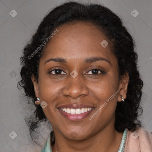 Joyful black young-adult female with long  black hair and brown eyes