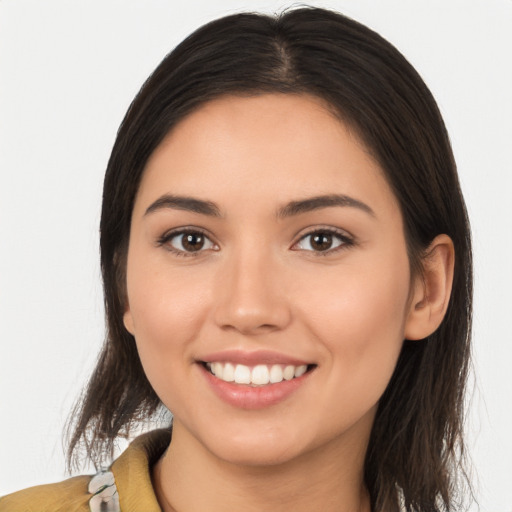 Joyful white young-adult female with long  brown hair and brown eyes