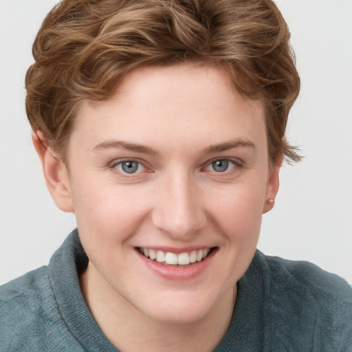 Joyful white young-adult female with short  brown hair and grey eyes