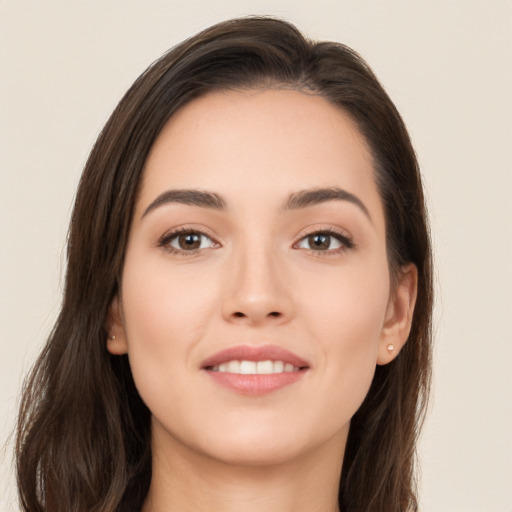 Joyful white young-adult female with long  brown hair and brown eyes