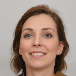 Joyful white young-adult female with medium  brown hair and grey eyes