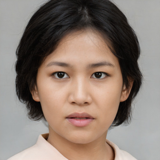Neutral asian young-adult female with medium  brown hair and brown eyes