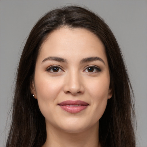 Joyful white young-adult female with long  brown hair and brown eyes