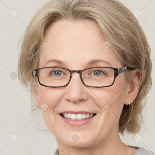 Joyful white adult female with medium  brown hair and blue eyes