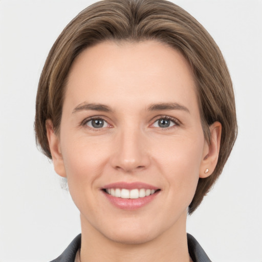 Joyful white young-adult female with medium  brown hair and grey eyes