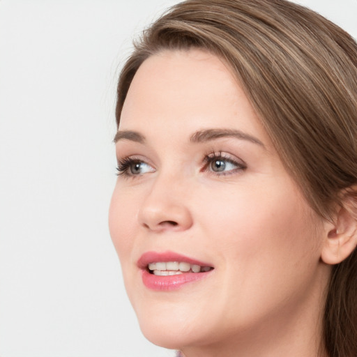 Joyful white young-adult female with medium  brown hair and blue eyes