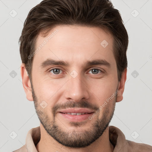 Joyful white young-adult male with short  brown hair and brown eyes