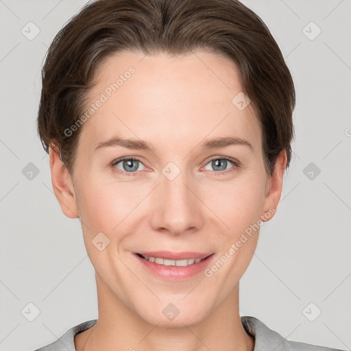 Joyful white young-adult female with short  brown hair and grey eyes