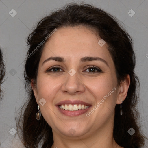 Joyful white adult female with long  brown hair and brown eyes