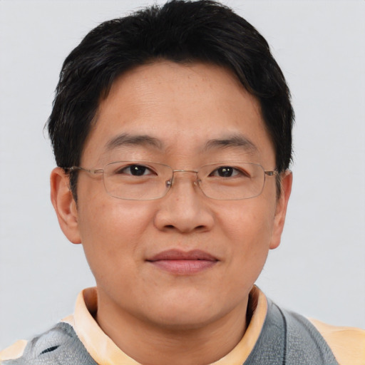 Joyful asian adult male with short  brown hair and brown eyes