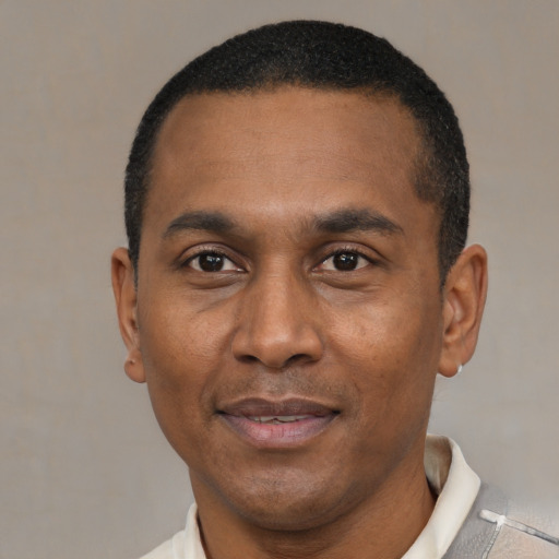Joyful latino adult male with short  black hair and brown eyes