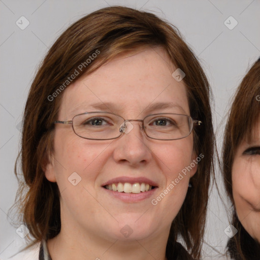 Joyful white adult female with medium  brown hair and blue eyes