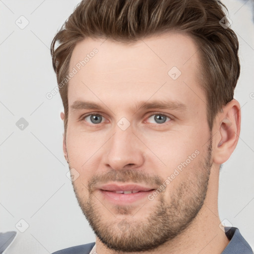 Joyful white young-adult male with short  brown hair and grey eyes