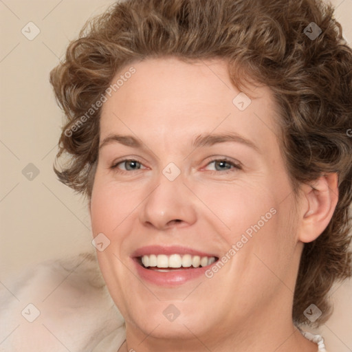 Joyful white adult female with medium  brown hair and green eyes