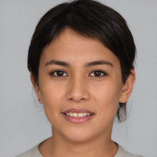 Joyful asian young-adult female with short  brown hair and brown eyes