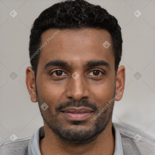 Joyful black young-adult male with short  black hair and brown eyes