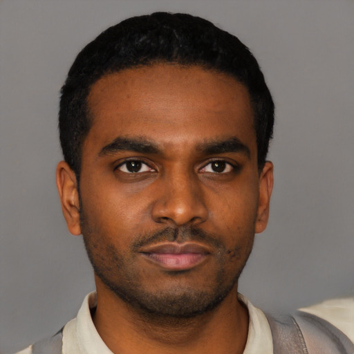 Neutral latino young-adult male with short  black hair and brown eyes
