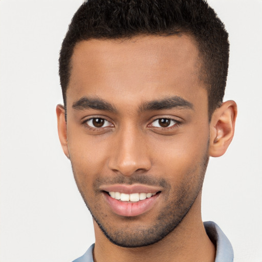 Joyful black young-adult male with short  brown hair and brown eyes