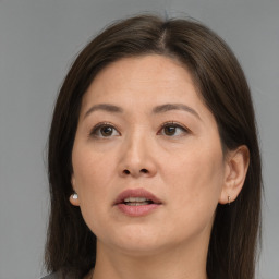 Joyful white adult female with long  brown hair and brown eyes