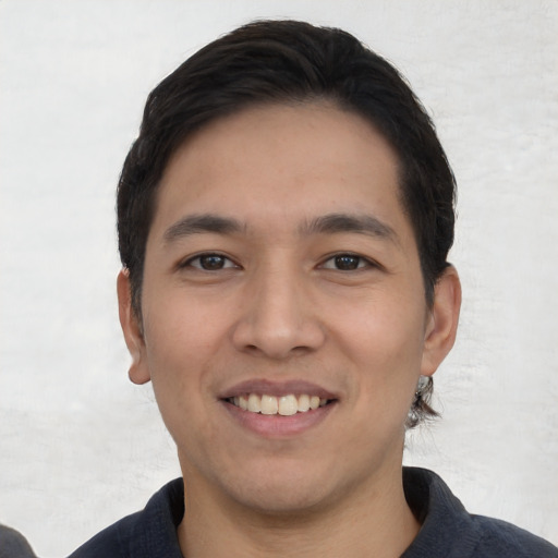 Joyful white young-adult male with short  black hair and brown eyes
