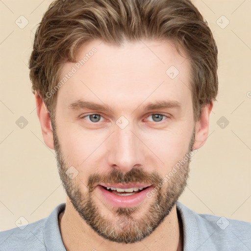 Joyful white young-adult male with short  brown hair and grey eyes