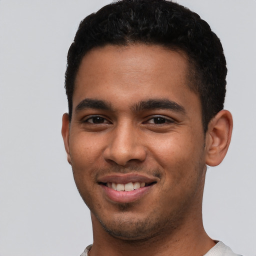 Joyful latino young-adult male with short  black hair and brown eyes