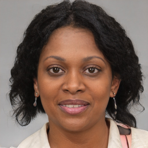 Joyful black young-adult female with medium  brown hair and brown eyes