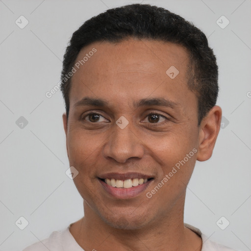 Joyful latino adult male with short  black hair and brown eyes