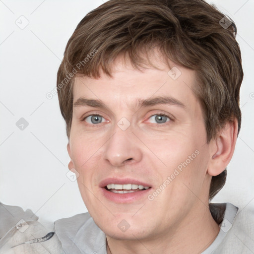 Joyful white adult male with short  brown hair and grey eyes