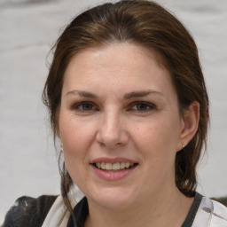 Joyful white adult female with medium  brown hair and brown eyes