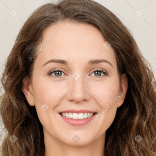 Joyful white young-adult female with long  brown hair and green eyes