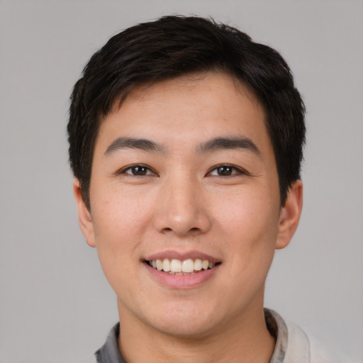 Joyful white young-adult male with short  black hair and brown eyes
