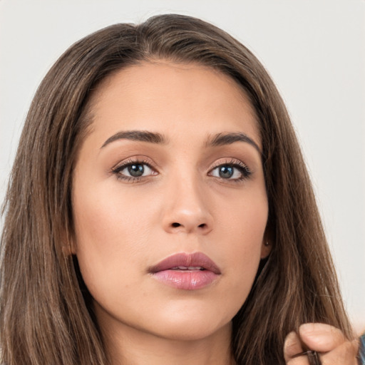 Neutral white young-adult female with long  brown hair and brown eyes