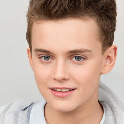 Joyful white child male with short  brown hair and brown eyes