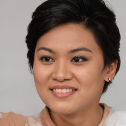 Joyful asian young-adult female with medium  brown hair and brown eyes