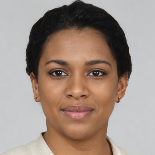 Joyful black young-adult female with short  black hair and brown eyes
