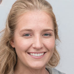 Joyful white young-adult female with long  brown hair and grey eyes