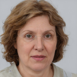 Joyful white adult female with medium  brown hair and blue eyes