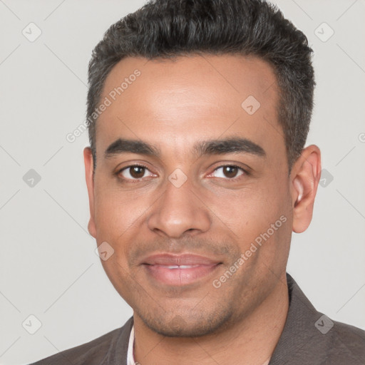 Joyful white young-adult male with short  black hair and brown eyes