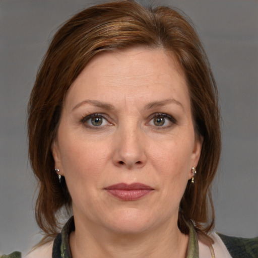 Joyful white adult female with medium  brown hair and brown eyes