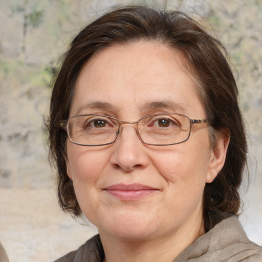 Joyful white middle-aged female with medium  brown hair and brown eyes