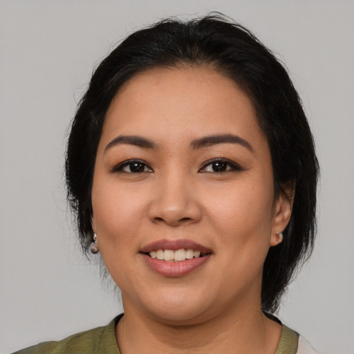 Joyful latino young-adult female with medium  black hair and brown eyes