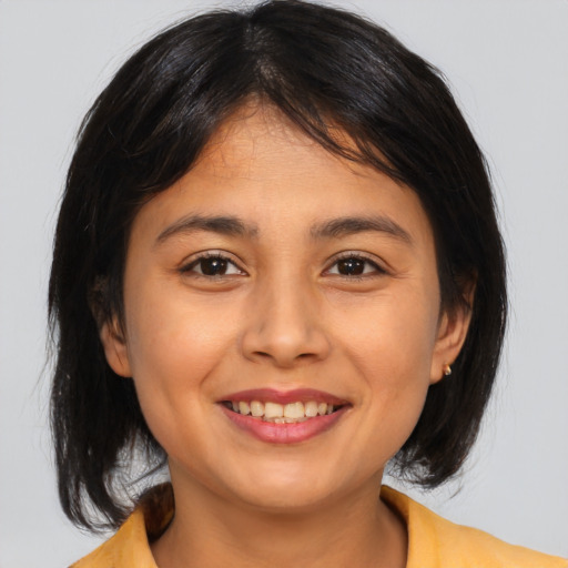 Joyful asian young-adult female with medium  brown hair and brown eyes