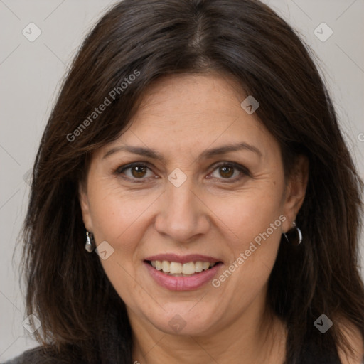 Joyful white adult female with long  brown hair and brown eyes