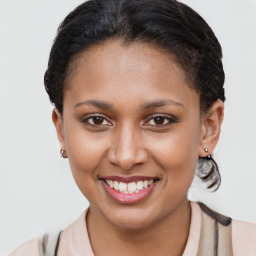 Joyful latino young-adult female with short  brown hair and brown eyes