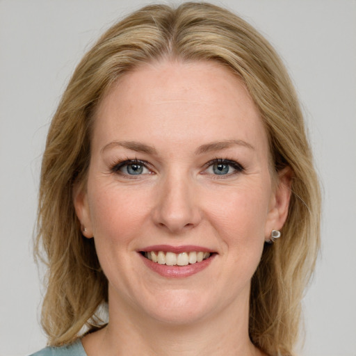 Joyful white young-adult female with medium  brown hair and blue eyes